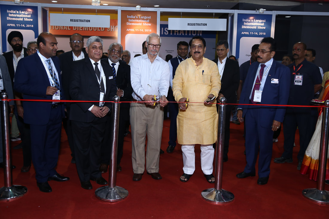 Man is cutting a ribbon on die & mold india 2018